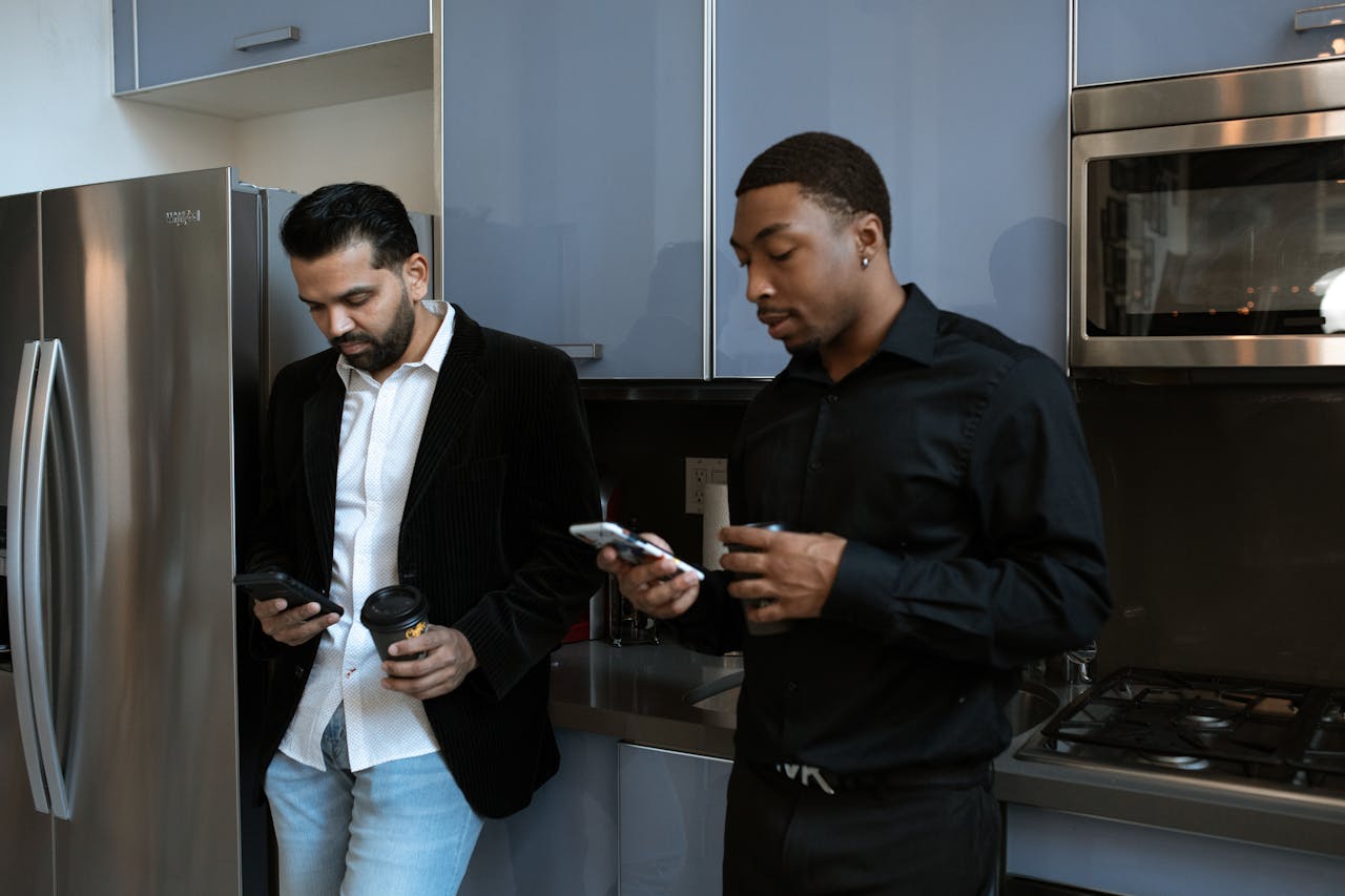 Two business professionals networking in a modern kitchen setting.